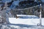 Selbst die Stromleitung ist vom Schnee förmlich umfasst, die diesen Hof mit dem nötigen Saft versorgt. Zu finden in der Nähe vom Christlessee im Trettachtal (Januar 2012)