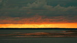 Herrlicher Sonnenuntergang über dem Watt der Nordseeinsel Föhr. Im Hintergrund die Nachbarinsel Amrum. Foto: Spätsommer 2014